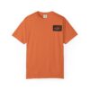 Orange t-shirt with a small black and orange patch on the chest.