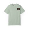 Light green t-shirt with a small black and red rectangular patch on the chest.