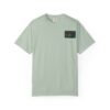 Light green t-shirt with a small black and red pocket logo.