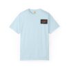 Light blue T-shirt with a black and red rectangular patch on the chest.