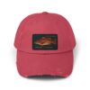 A red baseball cap with a fish patch on the front.