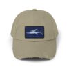 Beige baseball cap with a blue and white shark patch.
