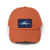 An orange baseball cap with a blue rectangular design.