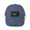 A blue baseball cap with a fishing scene patch.