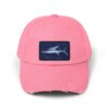 A pink baseball cap with a shark image on the front patch.