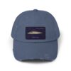 A blue baseball cap with a rectangular embroidered patch.