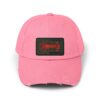 A pink baseball cap with a black and red patch on the front.