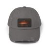 A gray baseball cap with a rectangular patch featuring a stylized sunset.