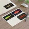 Four colorful cards with abstract designs on a white desk.
