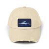 Beige baseball cap with a blue shark patch.