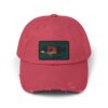 A red baseball cap with a rectangular patch showing a small image.