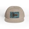 Beige cap with a blue patch featuring a crab illustration and text.