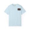 Light blue t-shirt with a small rectangular patch on the chest.