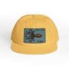 Yellow cap with a black patch featuring an octopus design.