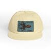 Beige cap with a blue patch featuring a detailed octopus design.