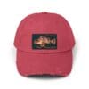 Red distressed baseball cap with a rectangular patch featuring a vintage camera design.