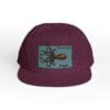 Maroon cap with an octopus patch and signature text.