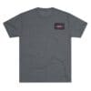 Grey t-shirt with a small rectangular logo on the chest pocket area.