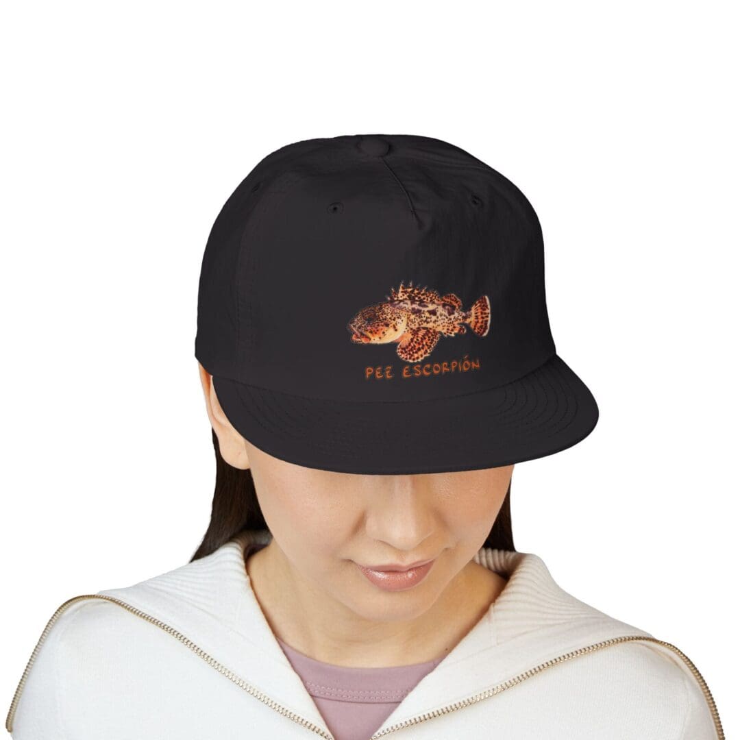 Person wearing a black cap with a flame design and a white hoodie.