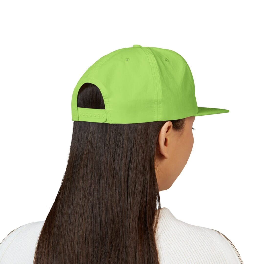 Person with long hair wearing a bright green cap, viewed from behind.
