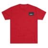 Red T-shirt with a small black logo patch on the chest.