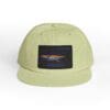 Light green cap with a black patch featuring a bird graphic.