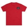 Plain red T-shirt with a small black logo patch on the chest.