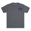 Gray T-shirt with a small blue and white logo on the chest pocket area.