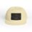 Beige baseball cap with a dark patch logo on front.