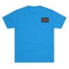 Bright blue t-shirt with a small black and red patch on the chest.