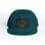 Teal snapback cap with a leather patch featuring an embossed fish design.