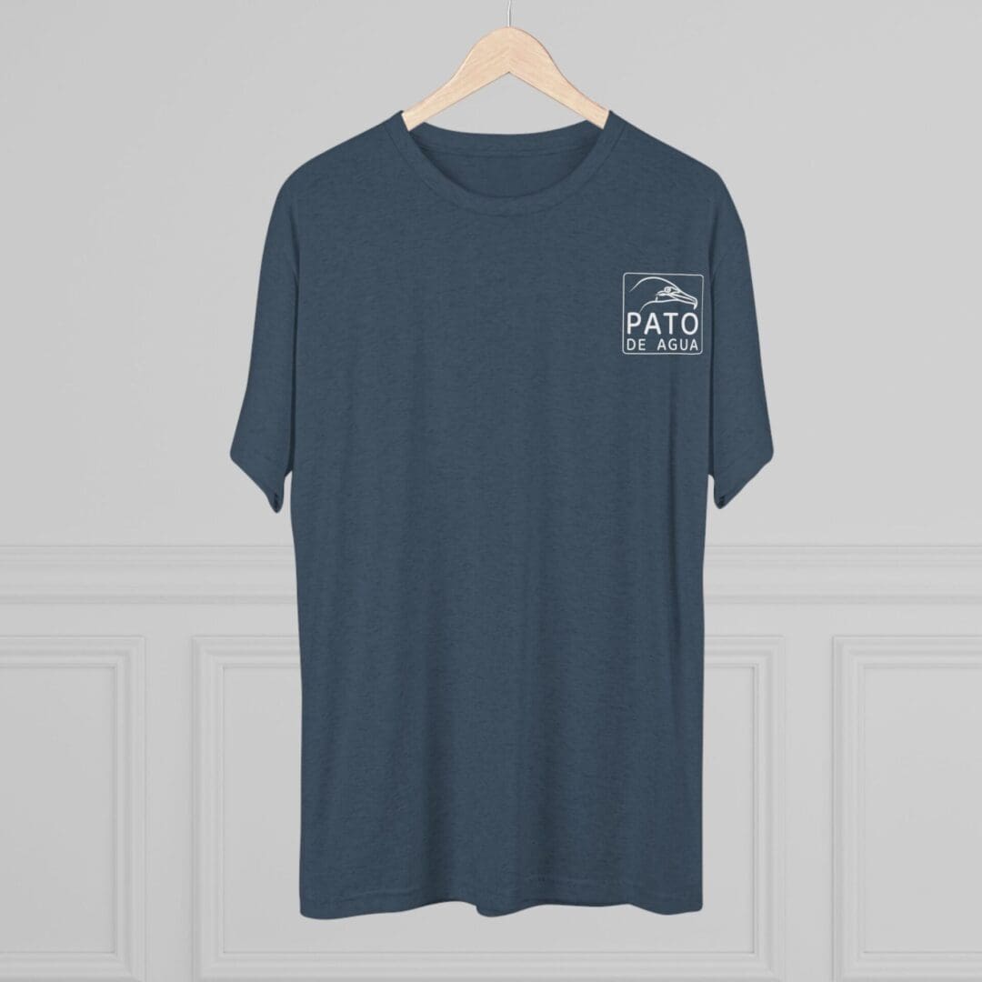 Blue T-shirt with a small white graphic on the chest hanging on a wooden hanger.