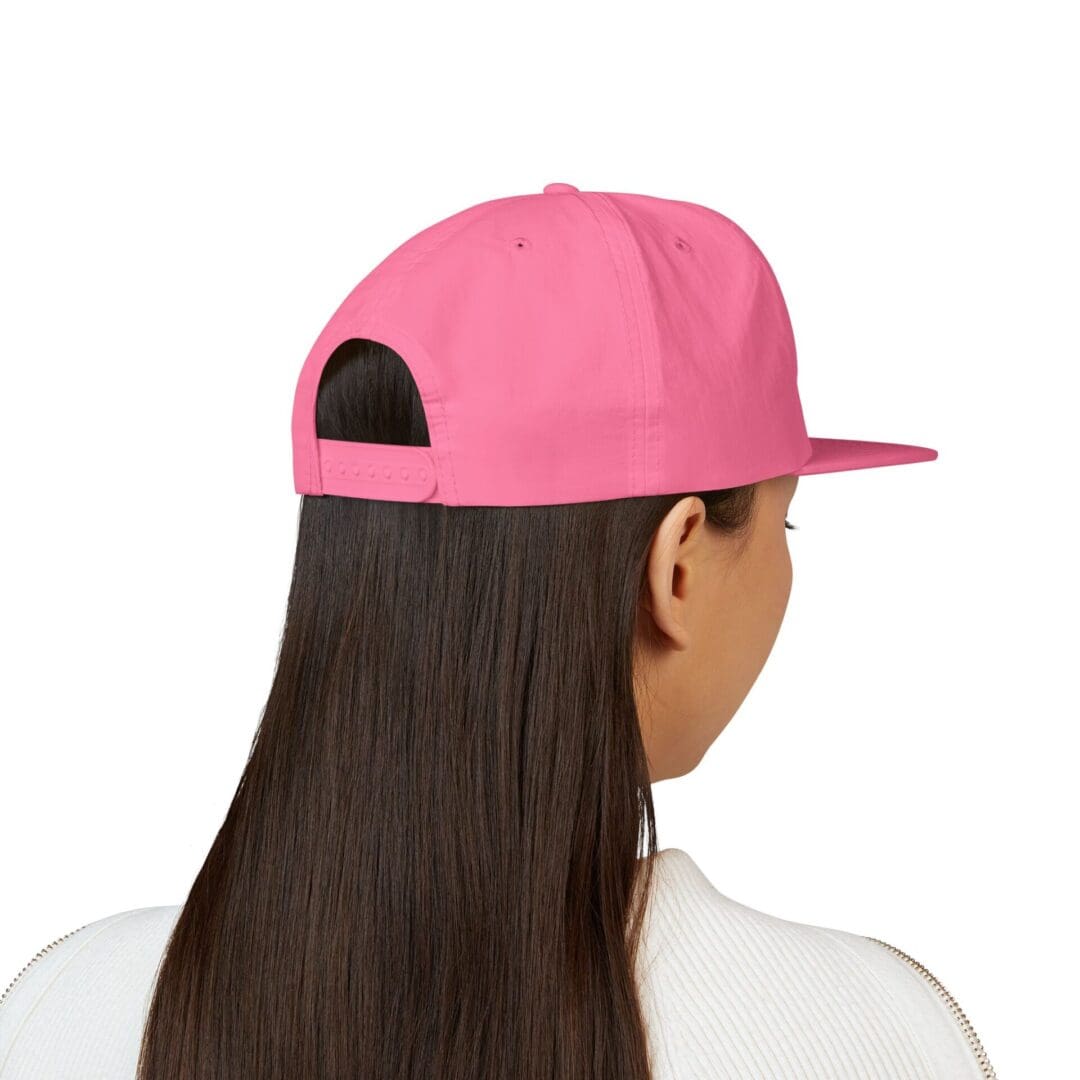 Person with long hair wearing a pink cap backwards.