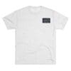 Plain white T-shirt with a small black rectangular patch on the chest.