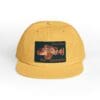 Yellow snapback hat with a vintage motorcycle patch.