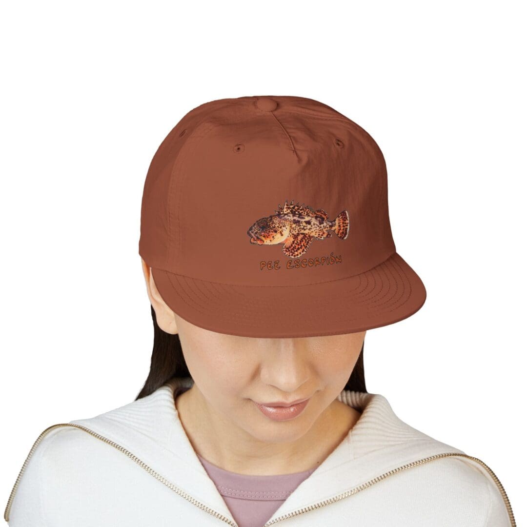 Person wearing a brown baseball cap looking down.