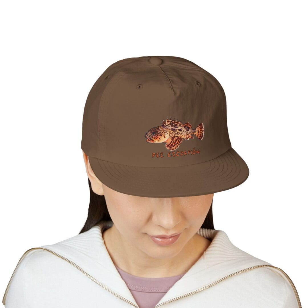 Person wearing a brown baseball cap and white hoodie.
