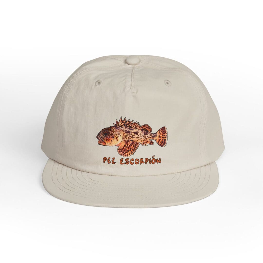 Beige cap with embroidered fish and 'THE ANGLER' text.