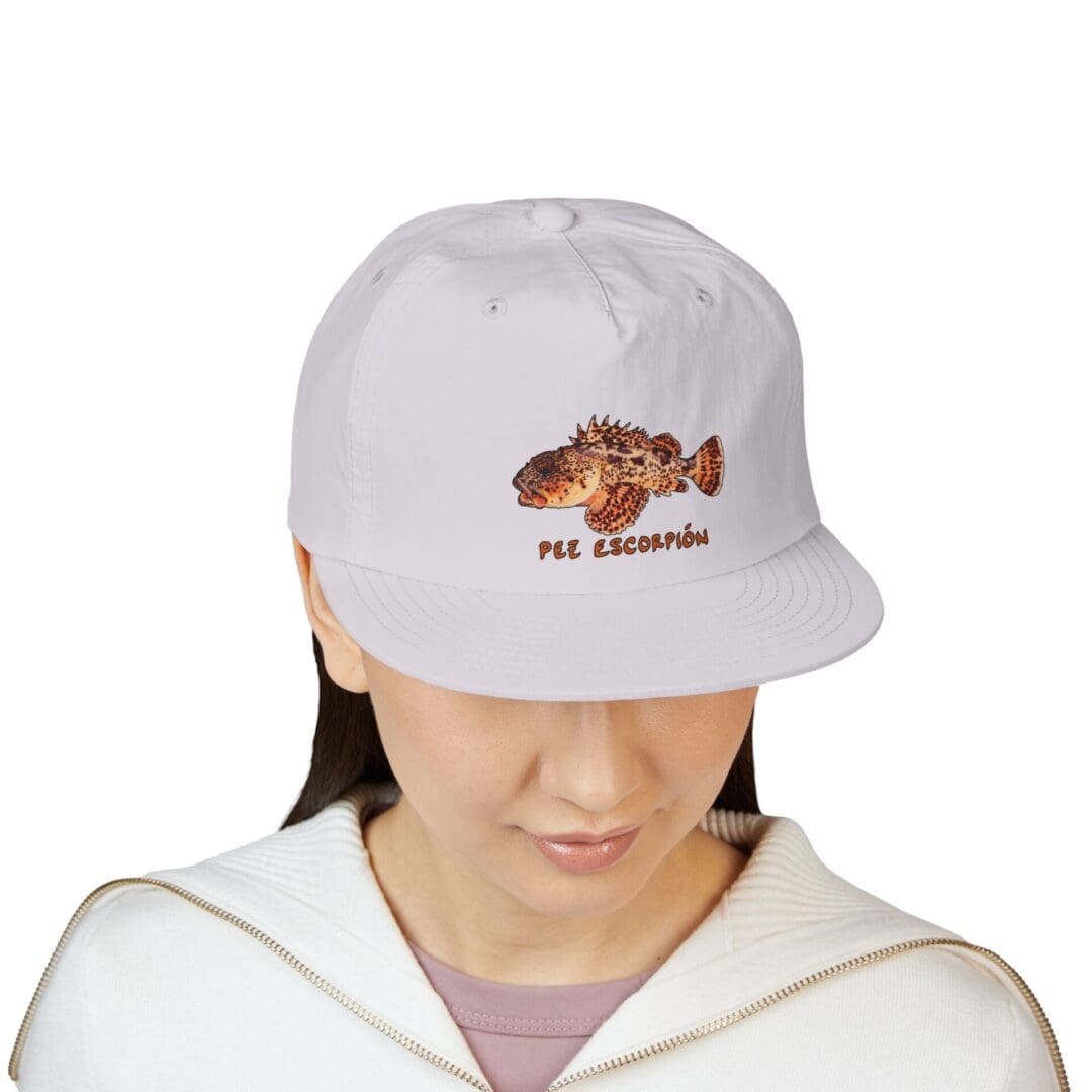 Person wearing a light gray baseball cap with a bear design and text.