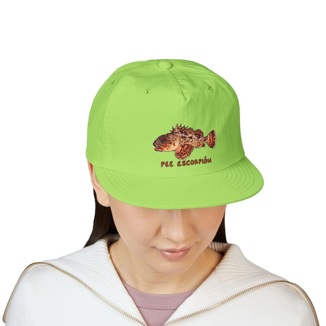 A person wearing a bright green cap with a hedgehog design.