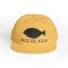 Yellow cap with black duck graphic and 'PATO DE AGUA' text.
