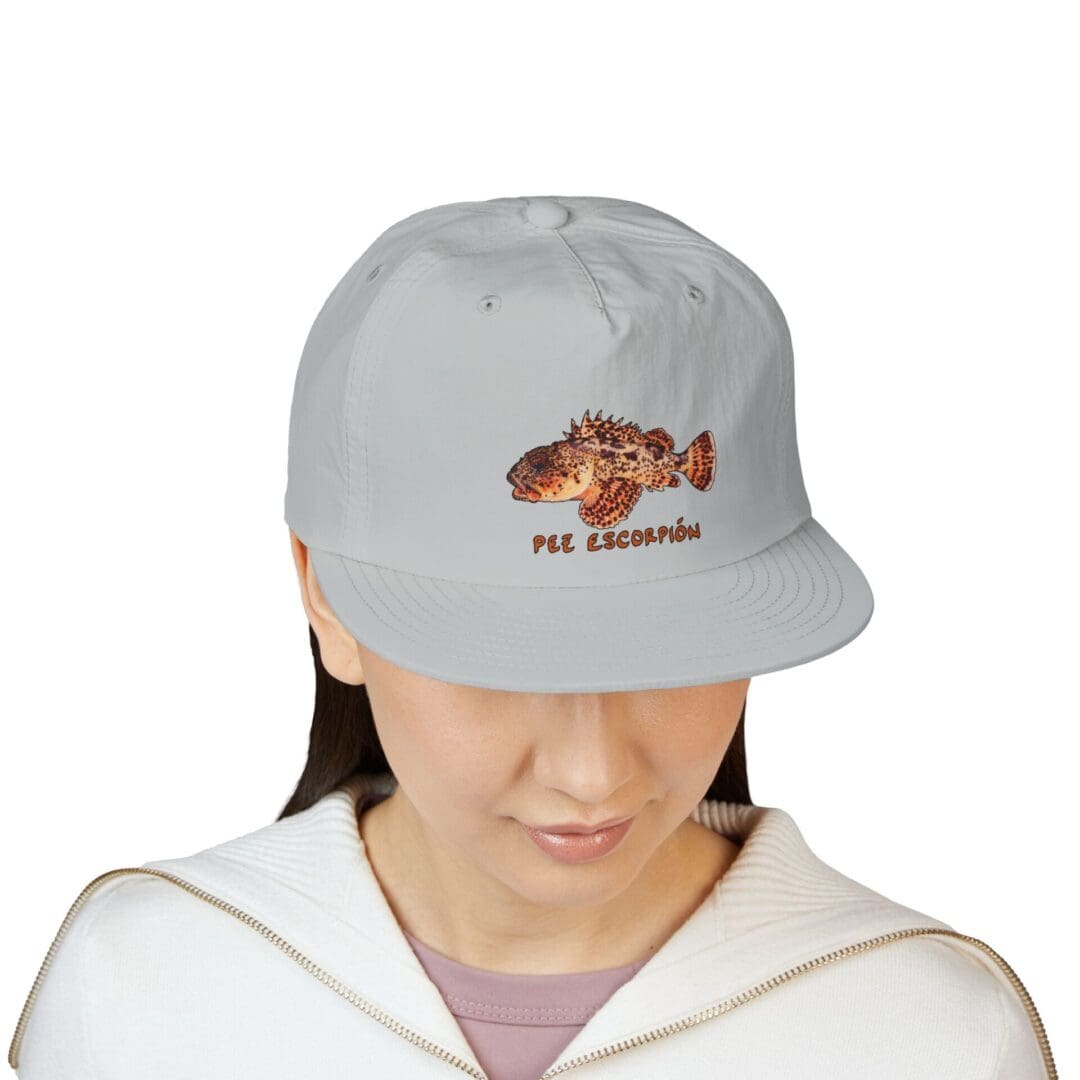 Person wearing a light gray cap with a hedgehog design.