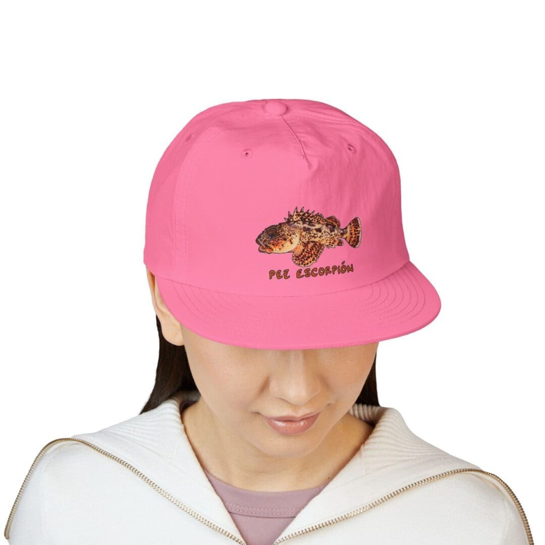 Person wearing a pink cap with a design on the front.