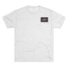 White t-shirt with a small black and purple rectangular logo on the chest.