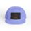 A purple snapback hat with a black patch featuring a fish design.