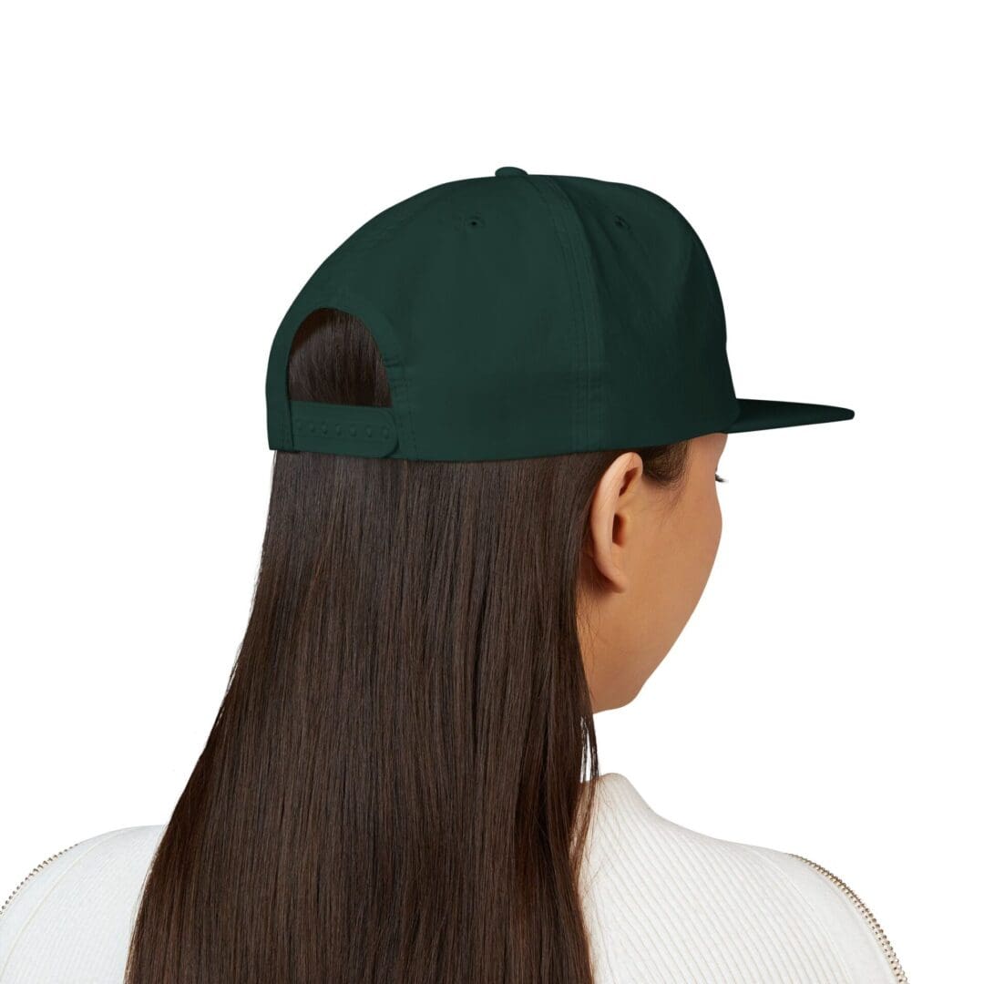 Person with long hair wearing a dark green cap, viewed from behind.